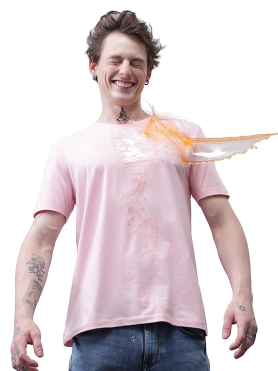 Person wearing a pink t-shirt with orange paint splashes on a white background
