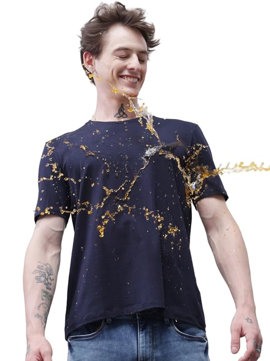 Man wearing a black t-shirt with gold abstract designs on a white background