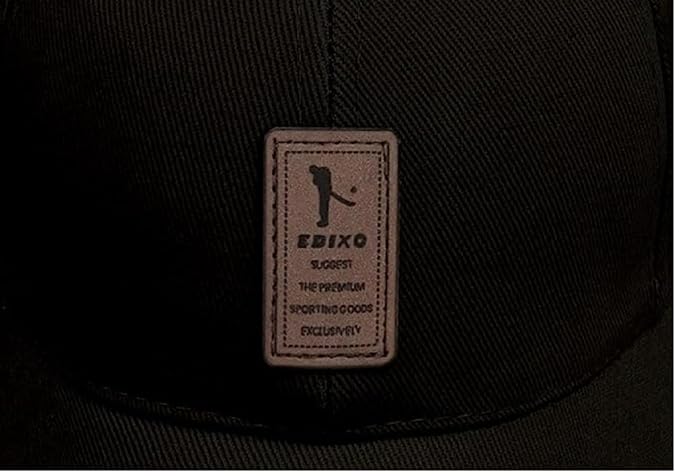 Close-up of a black cap with a visible brand label on a dark background